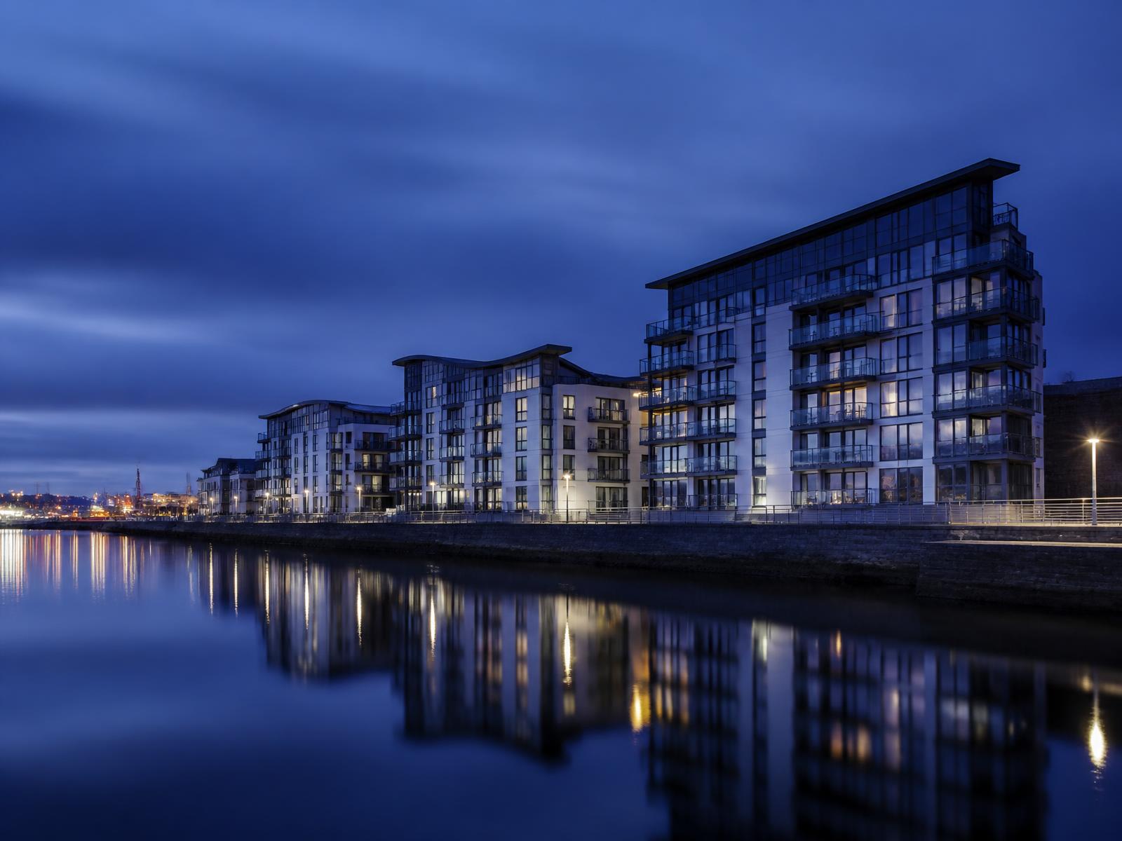 Waterfront apartment buildings in Cardiff Bay at dusk